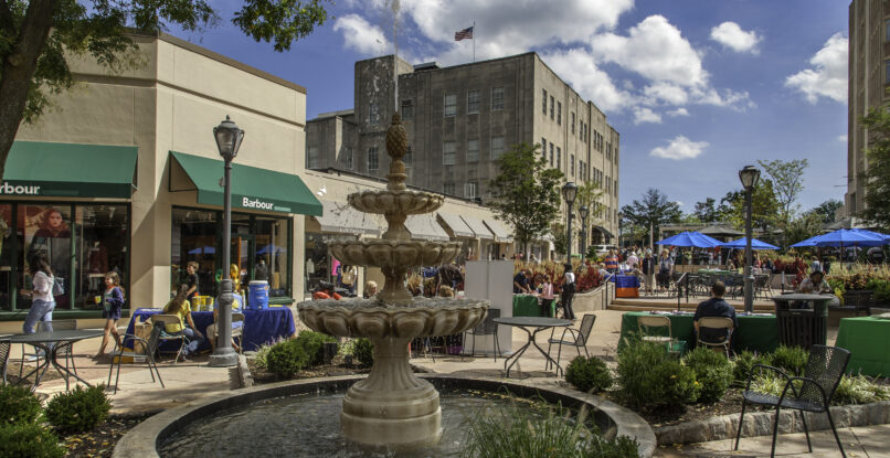 Downtown shopping area with a fountain.